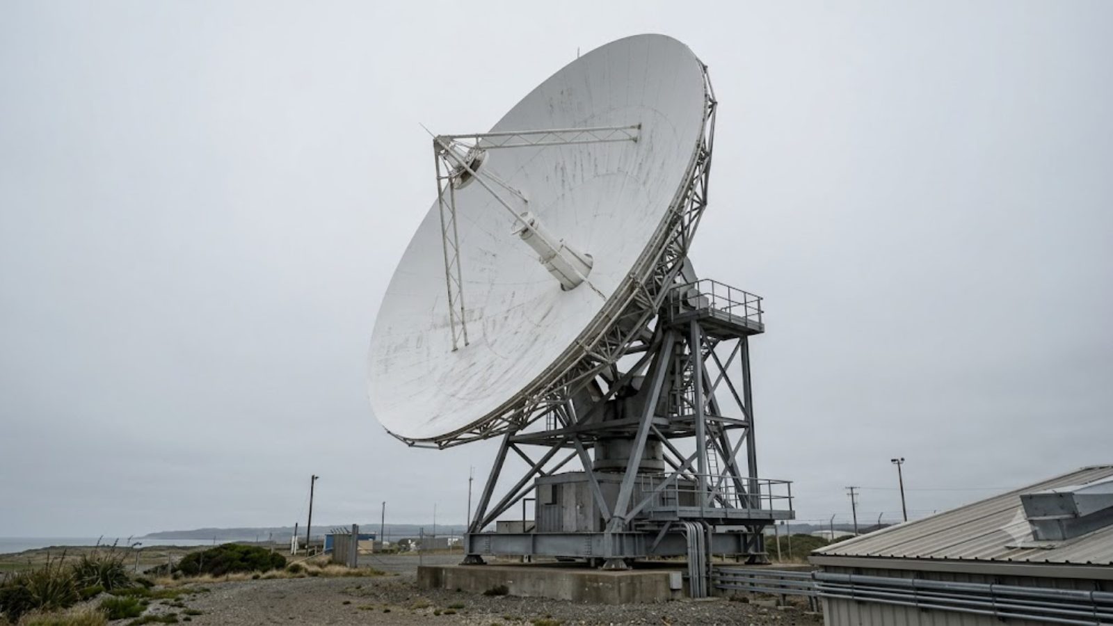 A radar array turning against a flat overcast sky