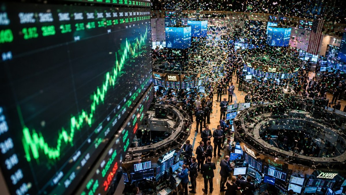Seen from above, a crowded stock exchange floor with traders around circular booths under bright monitors, confetti drifting down beside a giant green chart.